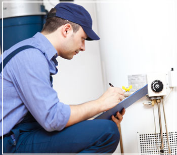 technician inspecting water heater