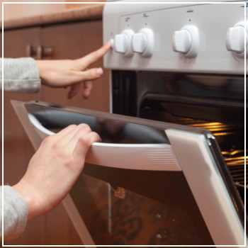 woman opening an oven 