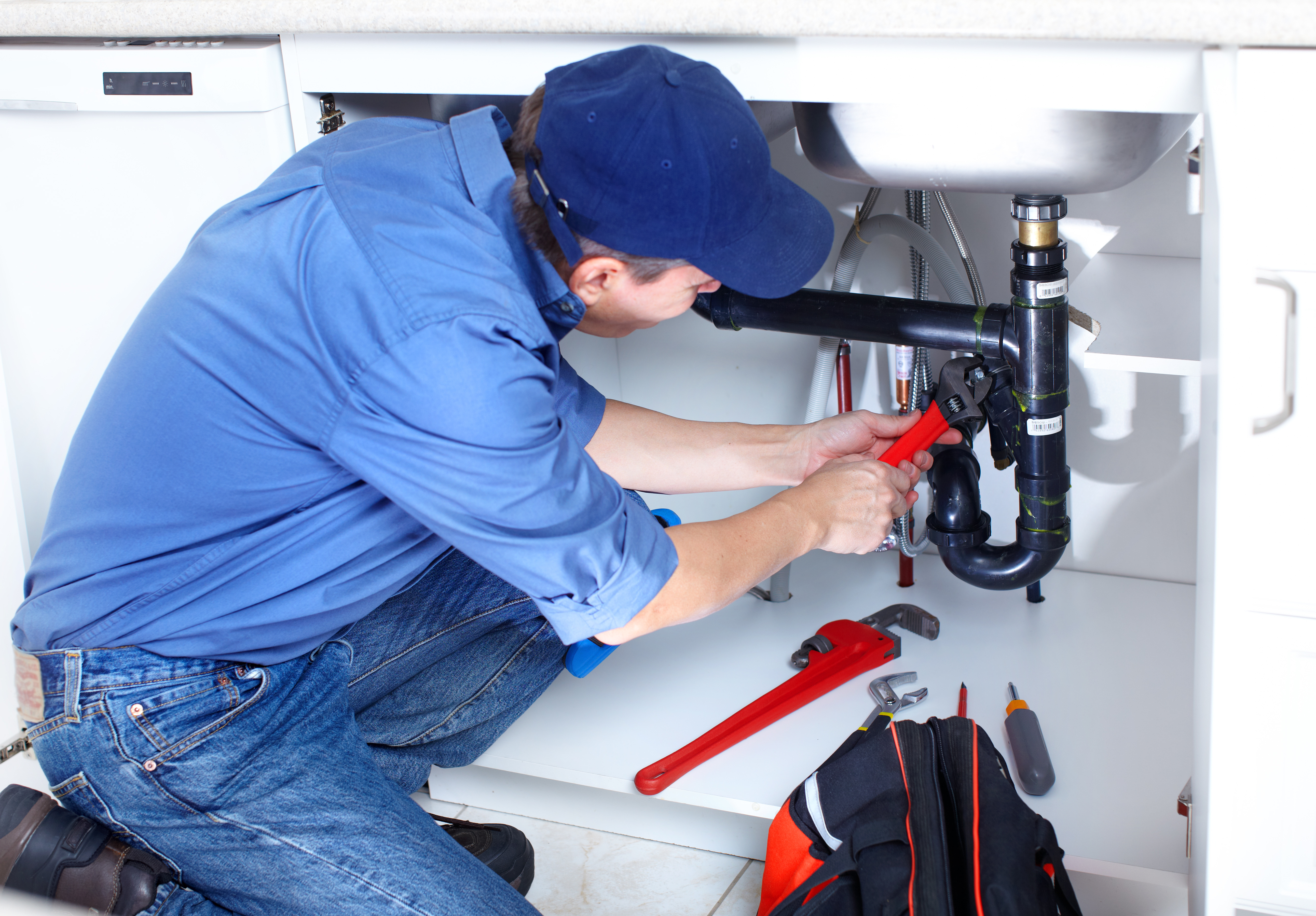 Plumber working on sink 