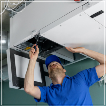 HVAC technician installing ventilation system