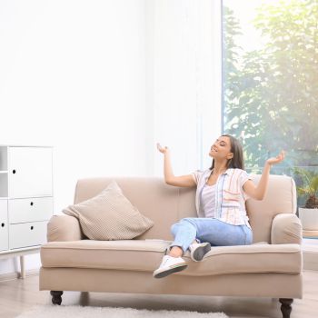 woman relaxing under air conditioner